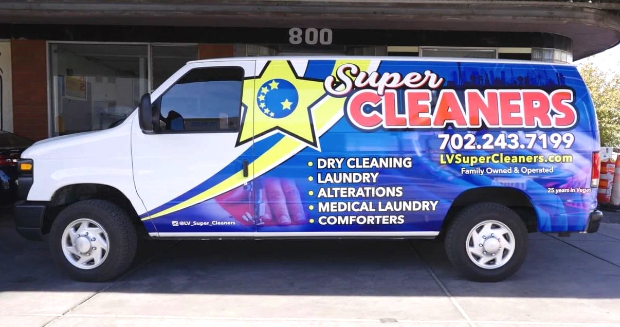 A super cleaners van is parked in front of a business. A super cleaners van is parked in front of a business.