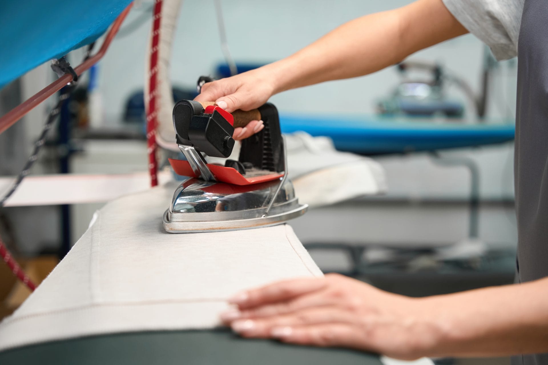 A person ironing a piece of cloth.